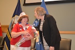 Winifred Woll, keynote speaker during the Memorial Day observation May 26, receives a thank you bouquet from Jackie Baxter, Philadelphia Compound Veterans Committee chairperson. The PCVC organized the ceremony.