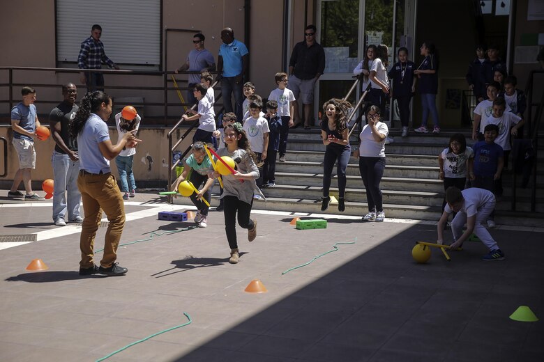 Marines and sailors with Special Purpose Marine-Air Ground Task Force Crisis Response-Africa, watch as children at 3rd Circolo Didattico ‘’Giovanni Paolo II’’ Gravina Di Catania, Italy, run through a circuit course the Marines set up, May 18, 2016.  The Marines and sailors interacted with the children, going over some English for an upcoming test, as well as creating and participating in games during the children’s recess period. (U.S. Marine Corps photo by Cpl. Alexander Mitchell/released)