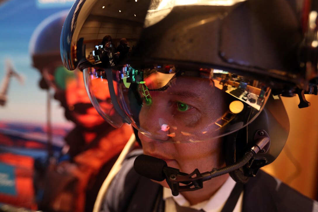 Daniel Maulet demonstrates the capabilities of the Thales TopOwl Flight Helmet during the 45th Annual Marine Corps Aviation Association Symposium and Marine Aviation Summit at New Bern, N.C., May 17, 2016. New technology was demonstrated to give a look into the latest advances in naval aviation. The TopOwl is an advanced helmet-mounted sight and display for helicopters designed providing pilots a heightened sense of awareness. Maulet is an employee with Thales. (U.S. Marine Corps photo by Cpl. N.W. Huertas/Released)