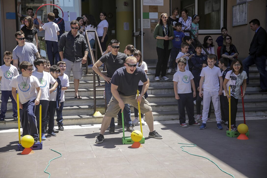 RPSA Alexander Varner, a religious program specialist with Special Purpose Marine-Air Ground Task Force Crisis Response-Africa, gets ready to run the circuit course with the children at 3rd Circolo Didattico ‘’Giovanni Paolo II’’ Gravina Di Catania, Italy, May 18, 2016.  The Marines and sailors interacted with the children, going over some English for an upcoming test, as well as creating and participating in games during the children’s recess period. (U.S. Marine Corps photo by Cpl. Alexander Mitchell/released)