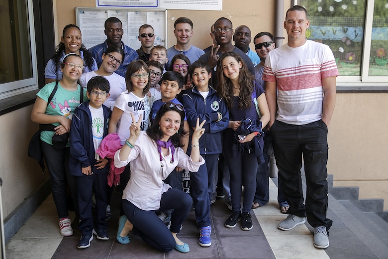 Marines and sailors with Special Purpose Marine-Air Ground Task Force Crisis Response-Africa, take a photo with children and staff at 3rd Circolo Didattico ‘’Giovanni Paolo II’’ Gravina Di Catania, Italy, May 18, 2016.  The Marines and sailors interacted with the children, going over some English for an upcoming test, as well as creating and participating in games during the children’s recess period. (U.S. Marine Corps photo by Cpl. Alexander Mitchell/released)