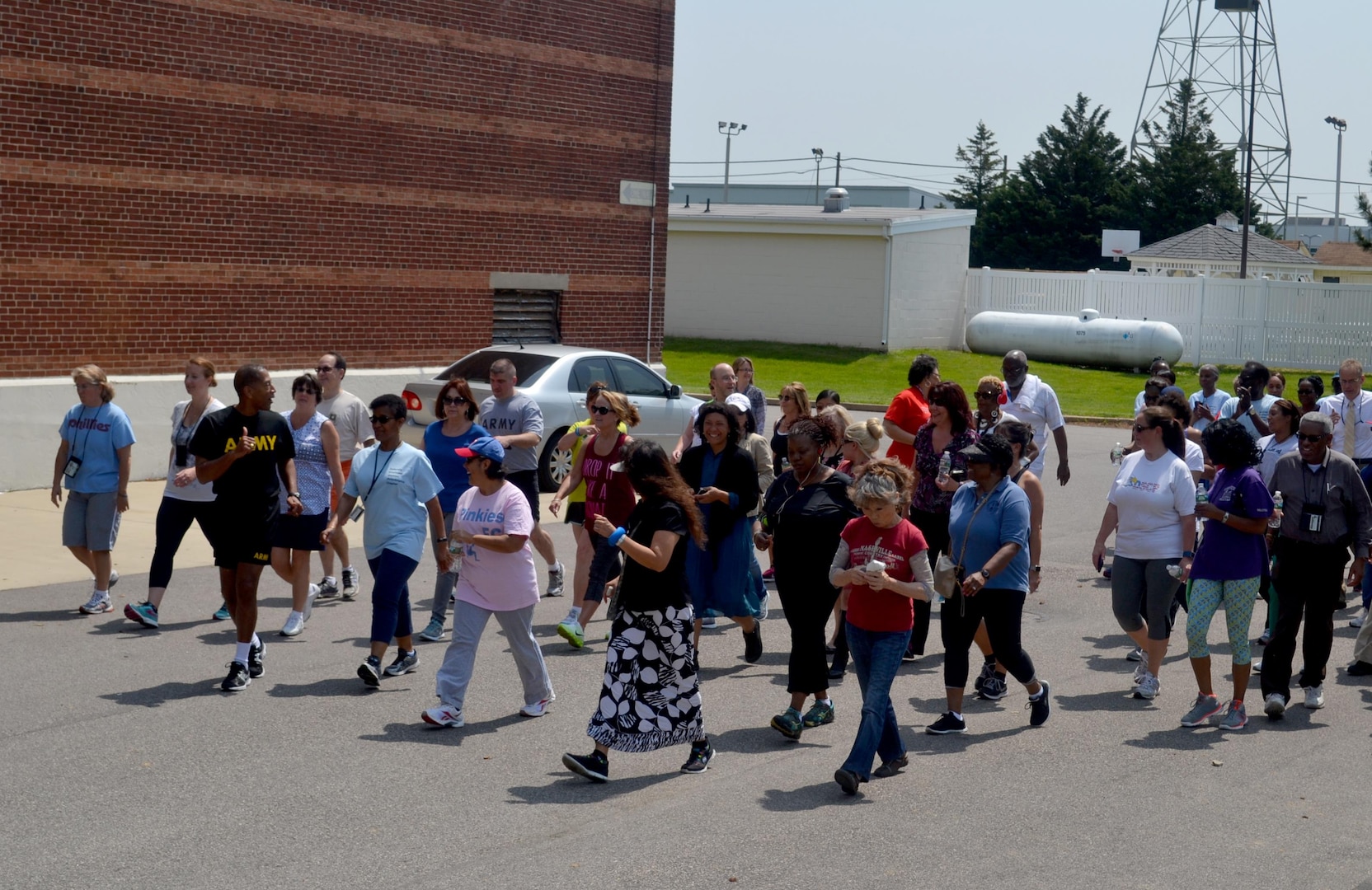 Defense Logistics Agency Troop Support Commander Army Brig. Gen. Charles Hamilton (left in black Army PT uniform) leads a group of participants at the second annual Federally Employed Women's 5K Walk/Run May 25. Hamilton encouraged employees to participate as part of DLA's resilience program.