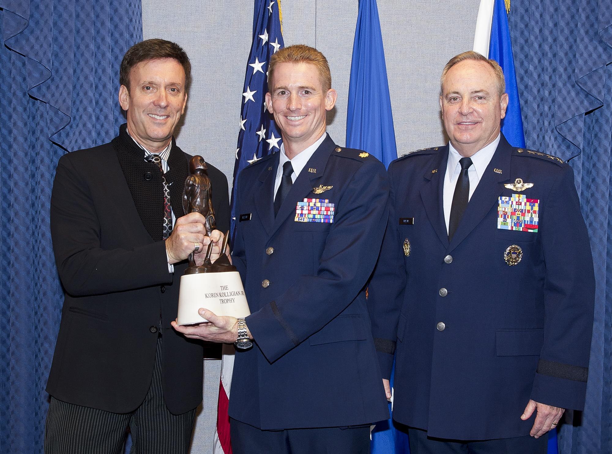 Kolligian family representative Corey Kolligian and Air Force Chief of Staff Gen. Mark A. Welsh III congratulate Maj. Jack Nelson during a ceremony at the Pentagon in Washington, D.C., May 25, 2016.  Nelson, from the 9th Reconnaissance Wing at Osan Air Base, South Korea, is the recipient of the 2015 Koren Kolligian Jr. Trophy for outstanding airmanship by an aircrew member who, by using extraordinary skills, averted or minimized the seriousness of an aircraft accident. (U.S. Air Force photo/Andy Morataya)