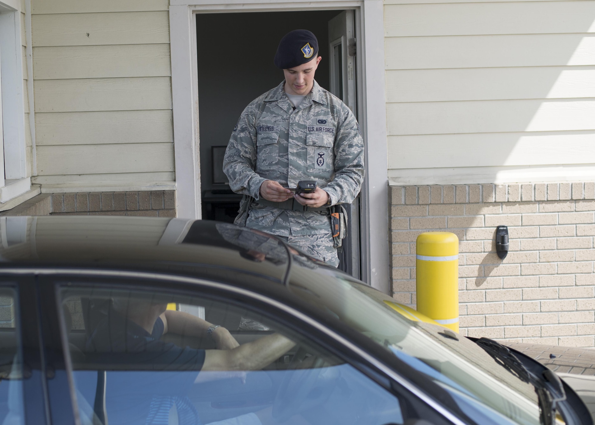 Staff Sgt. Christopher Steeves, security forces response force leader 512th Airlift Wing, checks photo IDs at a security gate May 12, 2016, Dover Air Force Base, Del. Steeves was mobilized to augment the 436th Security Force Squadron as they required additional manning during runway renovations. (U.S. Air Force Photo/Tech Sgt. Nathan Rivard)