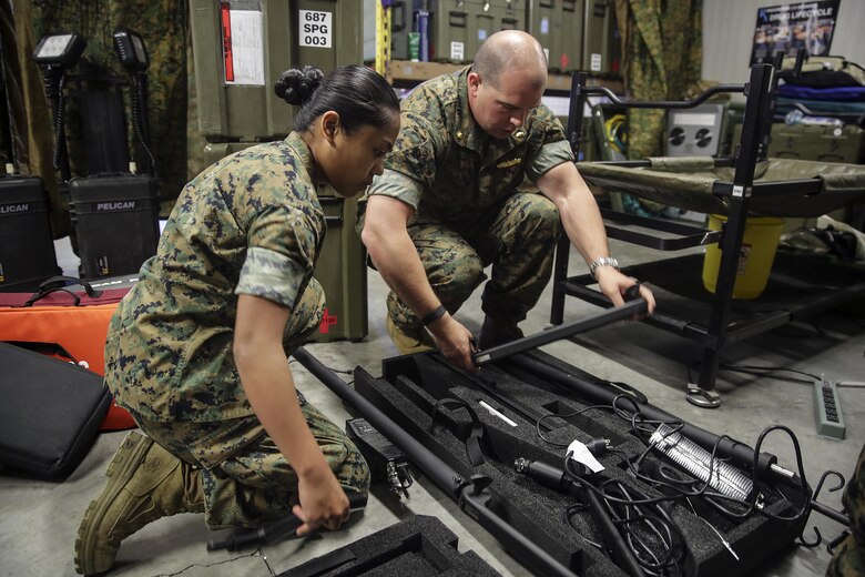 General surgeon Lt. Cmdr. Johnson Tummers and Corpsman HN Ricaley Ninobla, part of the Forward Resuscitative Surgical System-Shock Trauma Platoon, are preparing the operating table for shipping on Naval Air Station Sigonella, Italy, May 2, 2016.  The mission of the FRSS-STP is to sustain life and limb, maintain a fighting force as a theater asset and respond to all medical calls.  (U.S. Marine Corps photo by Cpl. Alexander Mitchell/released)