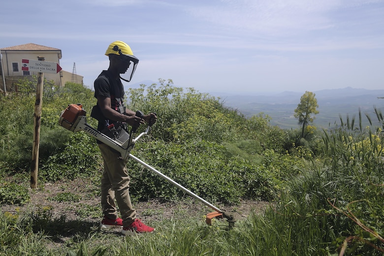Cpl. Chris Pittman, a motor transport Marine with Special Purpose Marine Air-Ground Task Force Crisis Response-Africa Logistics Combat Element, cuts grass and overgrowth at Castello di Lombardia in Enna, Sicily, on April 22, 2016, during a community relations project.  The Marines and sailors cleaned up garbage and debris on the castle grounds so the community can enjoy its beauty and landscape.  (U.S. Marine Corps photo by Cpl. Alexander Mitchell/released)