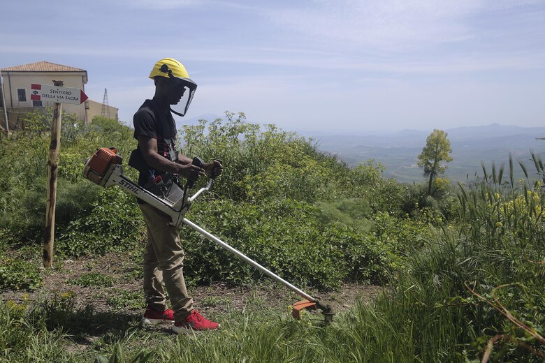 Cpl. Chris Pittman, a motor transport Marine with Special Purpose Marine Air-Ground Task Force Crisis Response-Africa Logistics Combat Element, cuts grass and overgrowth at Castello di Lombardia in Enna, Sicily, on April 22, 2016, during a community relations project.  The Marines and sailors cleaned up garbage and debris on the castle grounds so the community can enjoy its beauty and landscape.  (U.S. Marine Corps photo by Cpl. Alexander Mitchell/released)