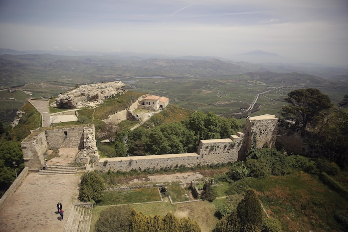 Marines with Special Purpose Marine Air-Ground Task Force Crisis Response-Africa Logistics Combat Element, cut overgrown grass and clean up debris at Castello di Lombardia during a community relations project on April 22, 2016.  Marines assist local areas in various projects to build relationships with the Sicilian government and people.  (U.S. Marine Corps photo by Cpl. Alexander Mitchell/released)