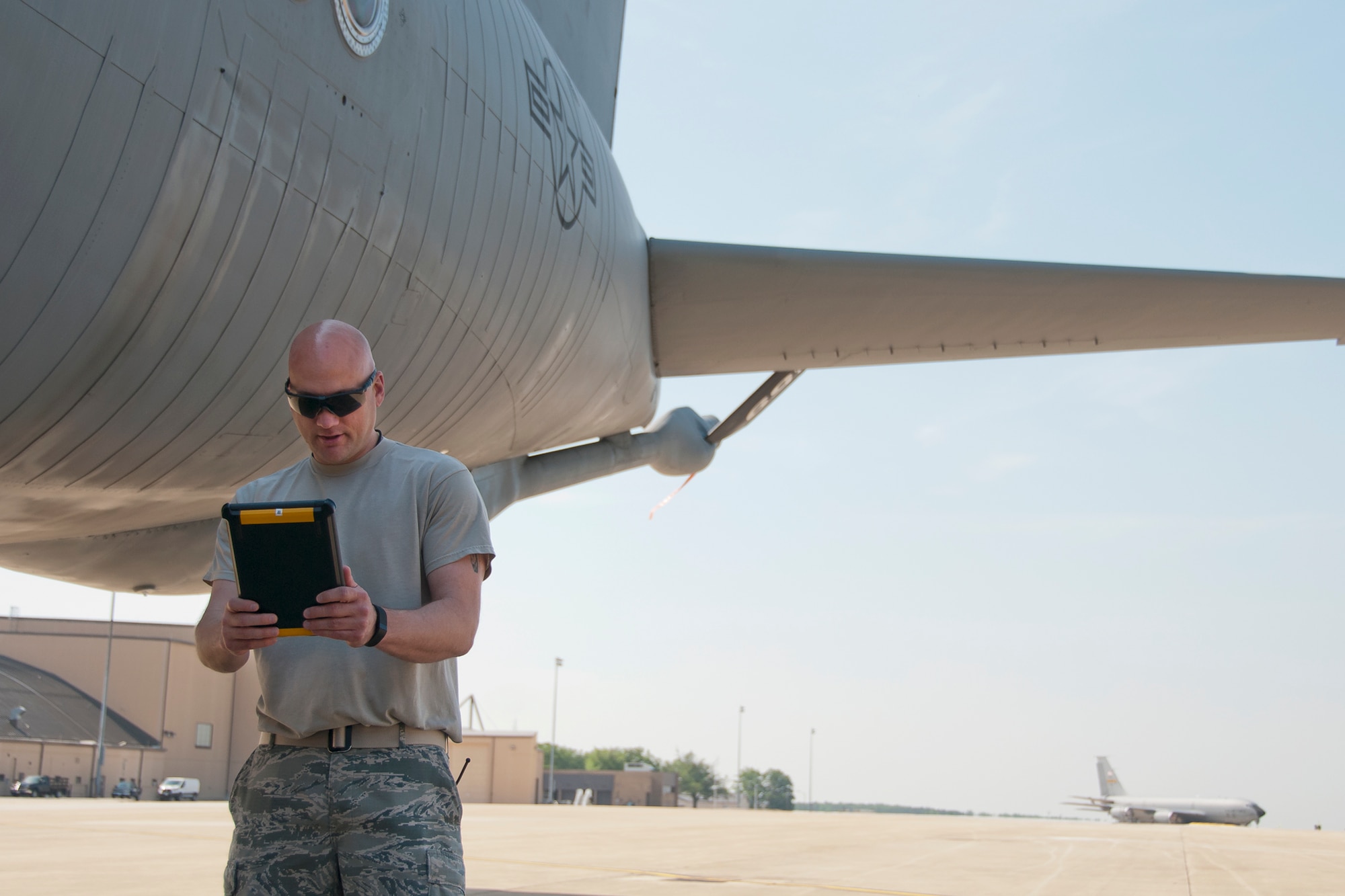 Senior Master Sgt. Ash Payton, 459th Maintenance Group aircraft overhaul supervisor, discusses a repair with one of his Airmen at a separate KC-135R Stratotanker location via video chat on the Joint Base Andrews, Md., flight line, May 26. Last week the 459th MXG obtained data connection on its tablets, which afforded access to communication applications such as instant messenger and video chat. This new capability allows maintainers to send imagery, instantly reach the shop or supervision, as well as discuss repair issues from separate locations in real-time through video stream. (U.S. Air Force photo/ Staff Sgt. Kat Justen)