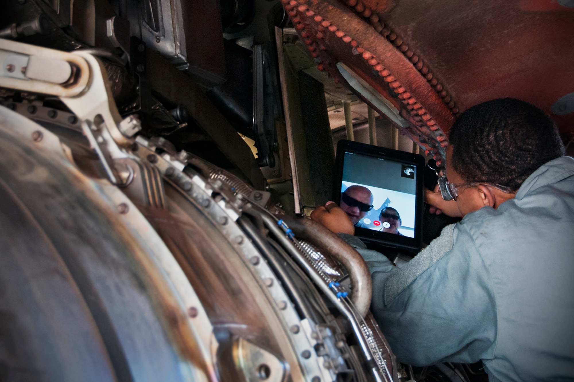 Technical Sgt. Tremain Strong, 459th Maintenance Group aerospace propulsion jet engine mechanic, shows an issue with a bleed on a KC-135R Stratotanker to his supervision via a tablet with video chat on the Joint Base Andrews, Md., flight line, May 26. Last week the 459th MXG obtained data connection on its tablets, which afforded access to communication applications such as instant messenger and video chat. This new capability allows maintainers to send imagery, instantly reach the shop or supervision, as well as discuss repair issues from separate locations in real-time through video stream. (U.S. Air Force photo/ Staff Sgt. Kat Justen)
