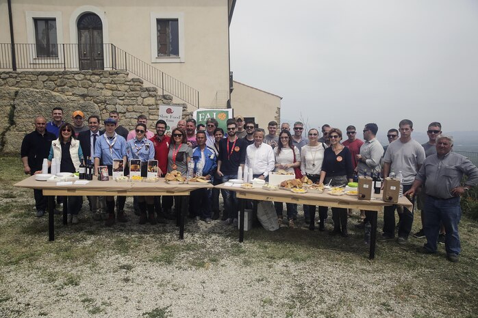Marines with Special Purpose Marine Air-Ground Task Force Crisis Response-Africa Logistics Combat Element, stand behind a table with lunch provided by the volunteers at Castello di Lombardia in Enna, Sicily, during a community relations project on April 22, 2016.  Marines assist local areas in various projects to build relationships with the Sicilian government and people.  (U.S. Marine Corps photo by Cpl. Alexander Mitchell/released)