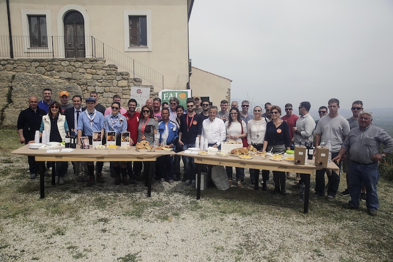 Marines with Special Purpose Marine Air-Ground Task Force Crisis Response-Africa Logistics Combat Element, stand behind a table with lunch provided by the volunteers at Castello di Lombardia in Enna, Sicily, during a community relations project on April 22, 2016.  Marines assist local areas in various projects to build relationships with the Sicilian government and people.  (U.S. Marine Corps photo by Cpl. Alexander Mitchell/released)