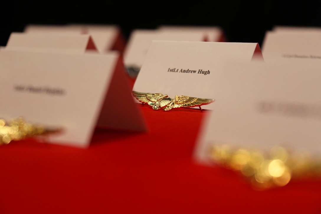 Naval aviator and crewmen wings are displayed on a table during a winging ceremony at New Bern, N.C., May 19, 2016. Naval aviatiors received the prestigious honor of receiving an iconic emblim, depicting the colmination of years of training, perserverence and sacrifice. Pilots and crewmen receive wings once they complete their respective training requirements and are then designated to join the fleet as an operational Marine Corps asset. The winging ceremony took place during the 45th Annual Marine Corps Aviation Assosiation Symposium and Marine Corps Aviation Summit. ( U.S. Marine Corps photo by Cpl. N.W. Huertas/ Released)