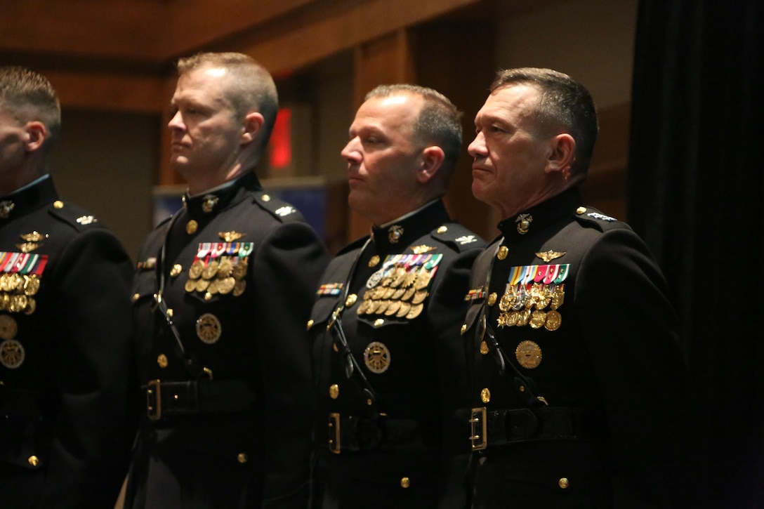 Lt. Gen. John M. Davis, right, Deputy Commandant for Aviation, joins senior leaders across the aviation community on stage during a winging ceremony at New Bern, N.C., May 19, 2016. Naval aviators received the prestigious honor of receiving an iconic emblem, depicting the culmination of years of training, perseverance and sacrifice. Pilots and crewmen receive wings once they complete their respective training requirements and are then designated to join the fleet as an operational Marine Corps asset. The winging ceremony took place during the 45th Annual Marine Corps Aviation Association Symposium and Marine Corps Aviation Summit. ( U.S. Marine Corps photo by Cpl. N.W. Huertas/ Released)