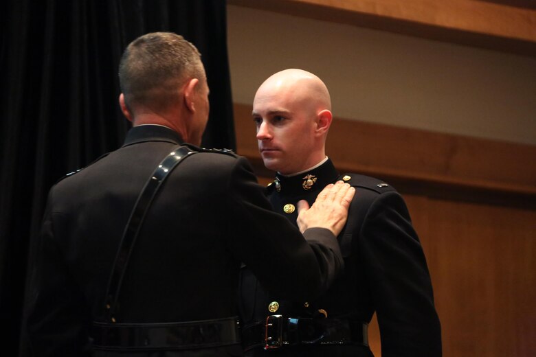 Lt. Gen. Jon M. Davis, left, Deputy Commandant for Aviation, pins wings on a young aviator during a winging ceremony at New Bern, N.C., May 19, 2016. Naval aviators received the prestigious honor of receiving an iconic emblem, depicting the culmination of years of training, perseverance and sacrifice. Pilots and crewmen receive wings once they complete their respective training requirements and are then designated to join the fleet as an operational Marine Corps asset. The winging ceremony took place during the 45th Annual Marine Corps Aviation Association Symposium and Marine Corps Aviation Summit. ( U.S. Marine Corps photo by Cpl. N.W. Huertas/ Released) 