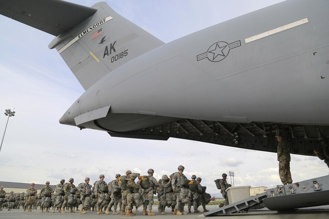 Paratroopers board an Air Force C-17 Globemaster III aircraft before participating in a joint airborne and air transportability training exercise at Joint Base Elmendorf-Richardson, Alaska, May 19, 2016. The aircraft crew is assigned to the 517th Airlift Squadron. Air Force photo by Alejandro Pena