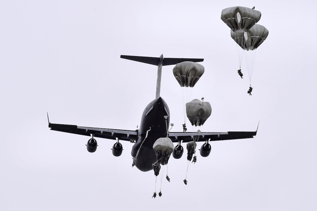 Paratroopers jump from an Air Force C-17 Globemaster III aircraft during a joint airborne and air transportability training exercise at Joint Base Elmendorf-Richardson, Alaska, May 19, 2016. Air Force photo by Alejandro Pena