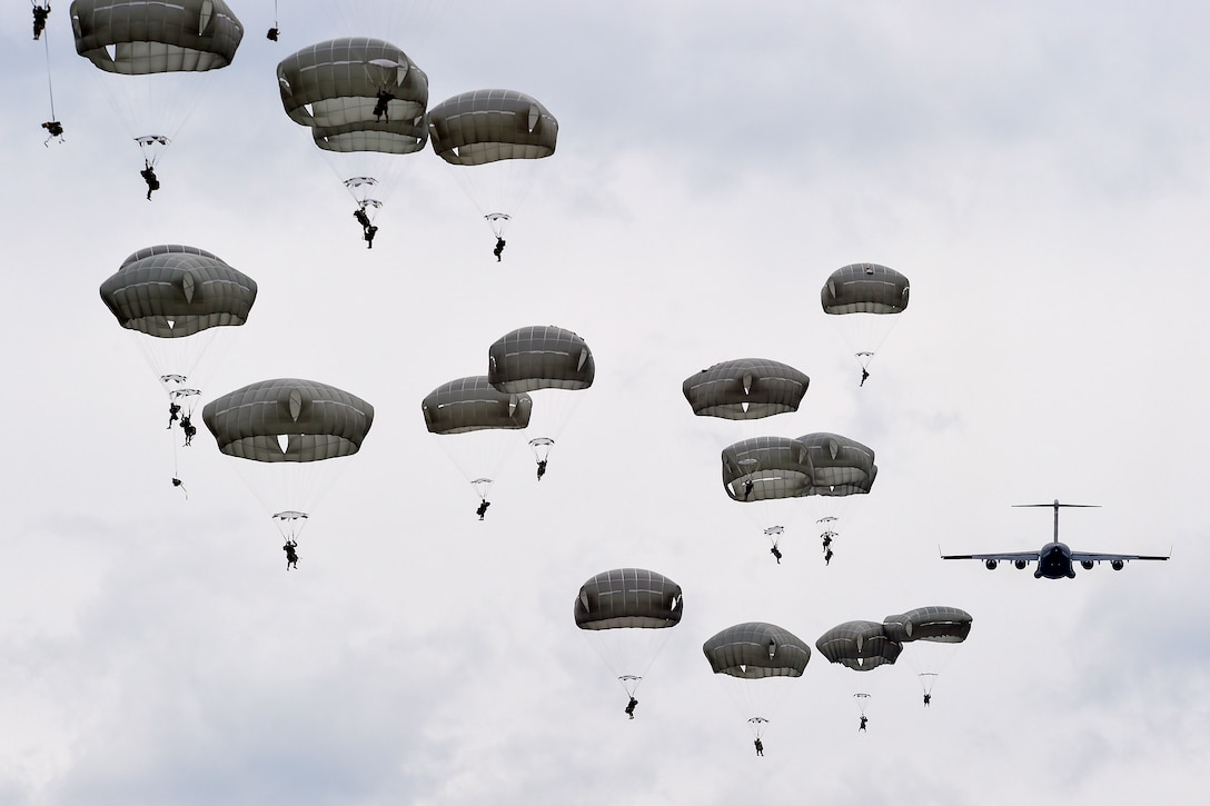 Paratroopers descend over Malemute drop zone during a joint airborne and air transportability training exercise at Joint Base Elmendorf-Richardson, Alaska, May 19, 2016. Air Force photo by Alejandro Pena 