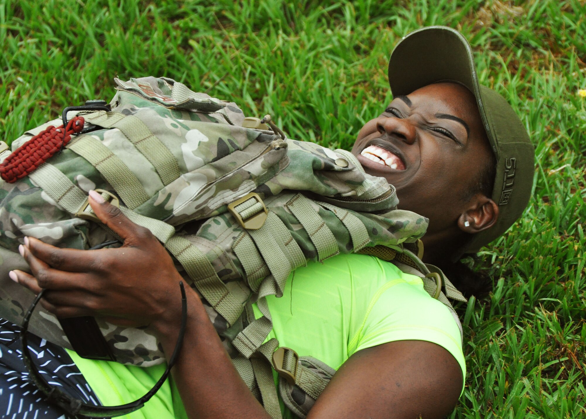 Staff Sgt. Rodane Williams from the 919th Special Operations Maintenance Group strains while doing leg raise warmups at a GoRuck Challenge event May 12, 2016 at Duke Field, Fla. The teambuilding exercise, based on special operations fitness training, put participants through a five-hour series of physically and mentally exhausting scenarios along an eight-mile ruck march.  (U.S. Air Force photo/Dan Neely)