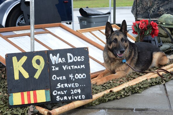 Luke, a retired military working dog, sits next to the U.S. War Dogs Association display at the 2016 Shaw Air Expo and open house, nicknamed "Thunder Over the Midlands," at Shaw Air Force Base, S.C., May 21, 2016. (U.S. Air Force photo/Senior Airman Zade Vadnais)