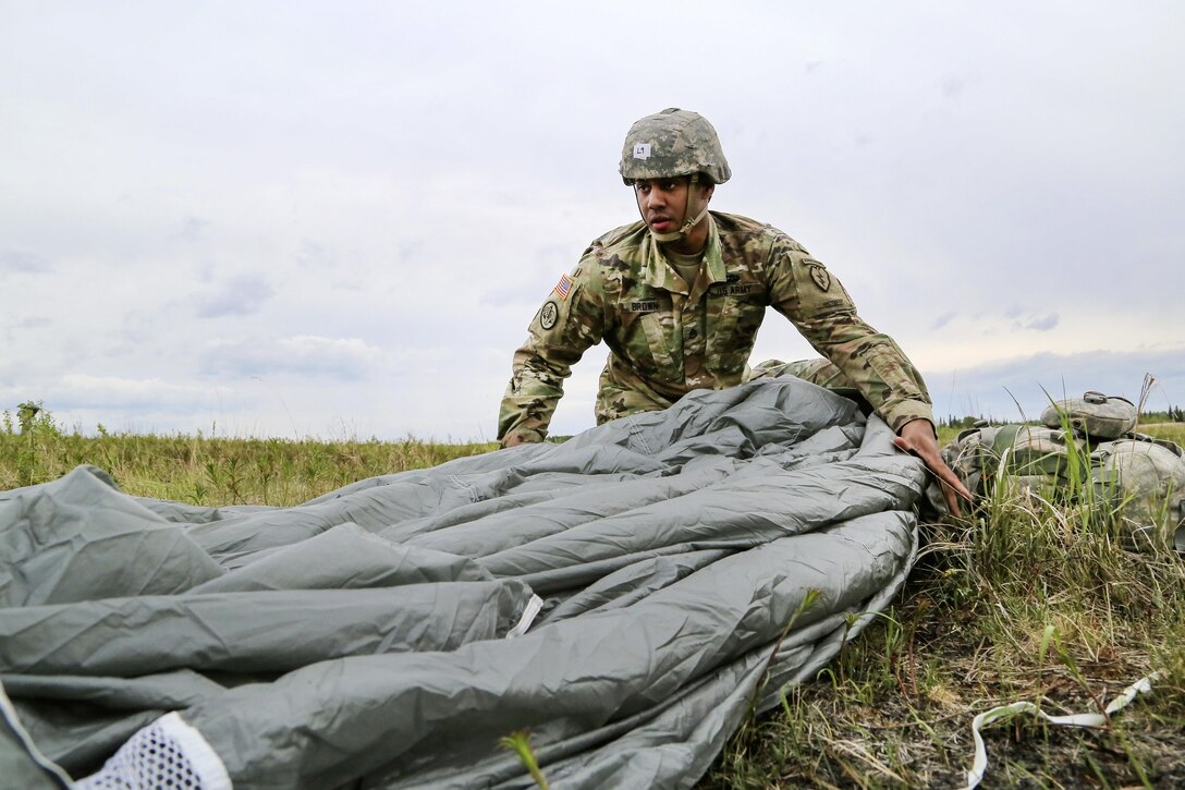 Army Staff Sgt. Kevin Brown recovers his parachute during a joint airborne and air transportability training exercise at Joint Base Elmendorf-Richardson, Alaska, May 19, 2016. Brown is assigned to the 25th Infantry Division’s 1st Battalion, 501st Parachute Infantry Regiment, 4th Brigade Combat Team (Airborne). Air Force photo by Alejandro Pena