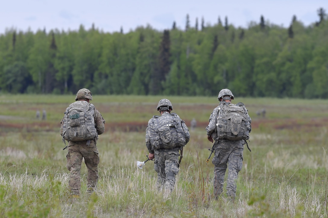 Paratroopers proceed to a rally and collection point after participating in a joint airborne and air transportability training exercise on Malemute drop zone at Joint Base Elmendorf-Richardson, Alaska, May 19, 2016. Air Force photo by Alejandro Pena