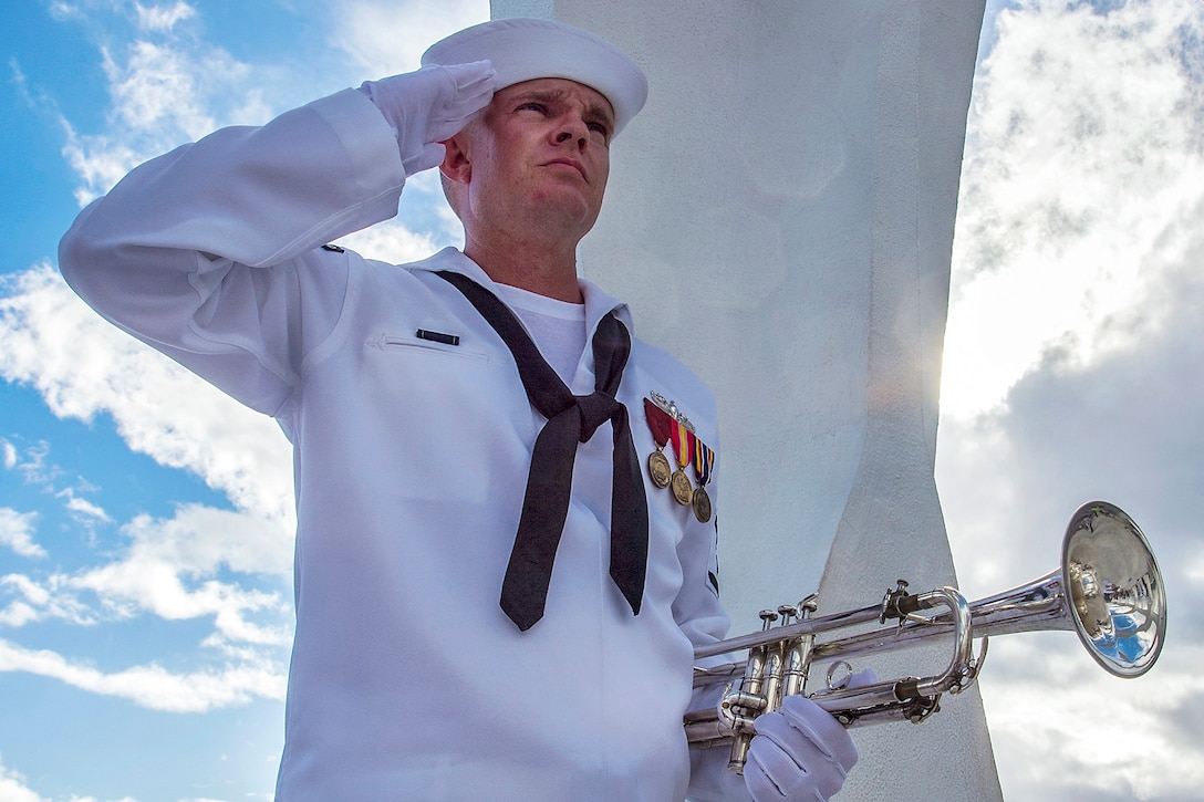 Navy Petty Officer 3rd Class Shelby Tucci, assigned to the Pacific Fleet Band, salutes after playing taps at the USS Arizona Memorial during a National Park Service sunset tour at Joint Base Pearl Harbor-Hickam, Hawaii, May 26, 2014. Navy photo by Petty Officer 1st Class Daniel Barker