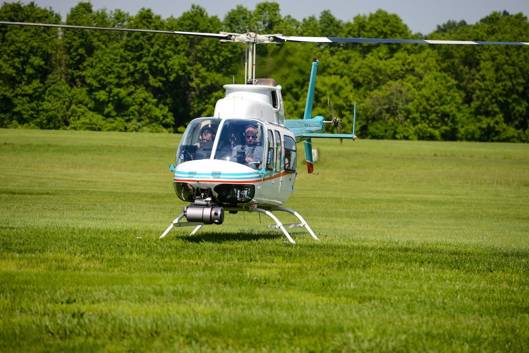 Pilots supervise a Bell 206 helicopter during tests of the attached Autonomous Aerial Cargo/Utility System in Bealeton, Virginia, May 25, 2016. Pilots make sure that the system can run smoothly and perform maneuvers the same way a human controlling it would