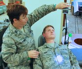 The 932nd Dentist on call keeping teeth ready for deployment is Capt. Tina Lucas Stoner, from the 932nd Airlift Wing, 932nd Medical Group, who worked along with simulated patients and members from the Aeromedical Staging Squadron and Medical Squadron as they all received skills training during a very warm and challenging May exercise at Patrick Air Force Base, Fla.  (U.S. Air Force photo by Maj. Stan Paregien)