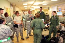 Lt. Col. James Stenger speaks to Critical Care Air Transportation Team Airmen and his 932nd Airlift Wing Medical Group members, who came from the Aeromedical Staging Squadron and Medical Squadron as energy and stress built up with the movement of simulated patients at their recent training event.  They all received skills training during a challenging exercise in May down at Patrick Air Force Base, Fla.  (U.S. Air Force photo by Maj. Stan Paregien)
