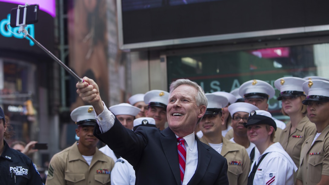 Secretary of the Navy Ray Mabus takes a selfie with a group of Marines and sailors during Fleet Week New York in Times Square, May 26, 2016. The Marines and sailors are visiting the city to interact with the public, demonstrate capabilities and teach the people of New York about America’s sea services.