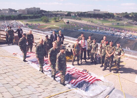 Service members display American flags at the Pentagon in Washington, D.C., for a 9/11 observance in 2002. (Courtesy photo)