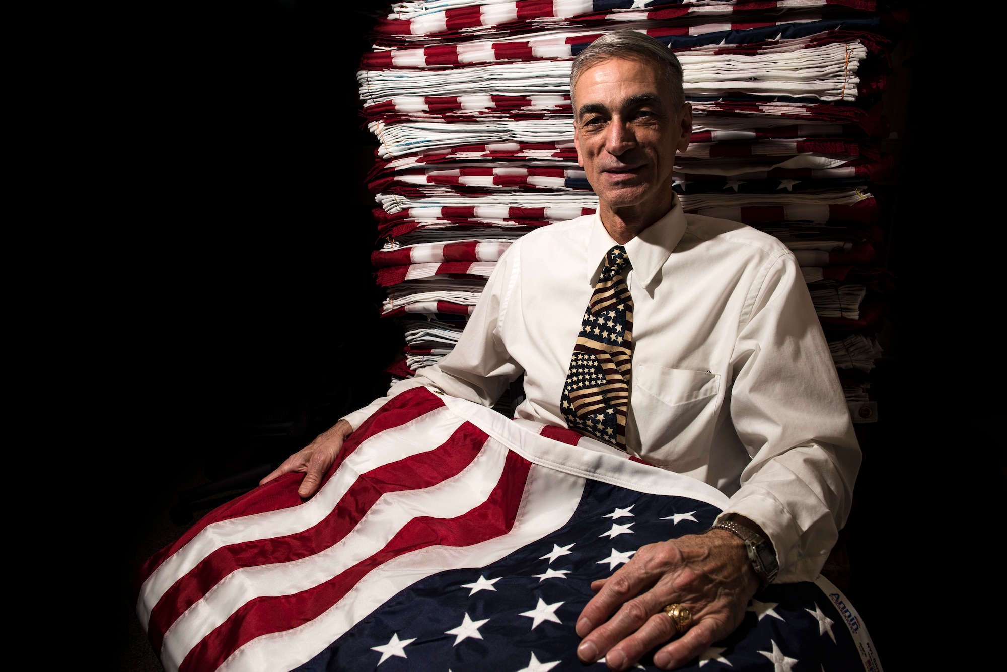 Army veteran Alvin Nieder poses with the flags that he and his team will raise outside the Pentagon in Washington, D.C., in honor of Memorial Day. Nieder has volunteered to organize this flag raising event since 2002. (U.S. Air Force photo/Staff Sgt. Alyssa Gibson)