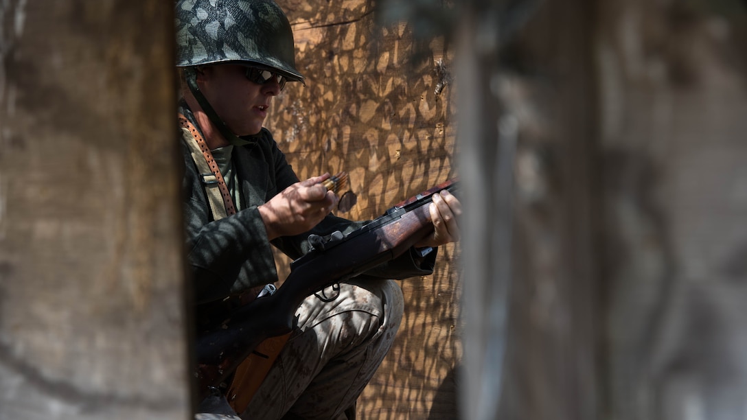 Staff Sgt. Stephanie A. Guebara reloads the M1 Garand during a World War II themed event at Marine Corps Base Quantico, Virginia, May 25, 2016. This course replicated fighting in trenches and the use of weapons by Marines in World War II. 