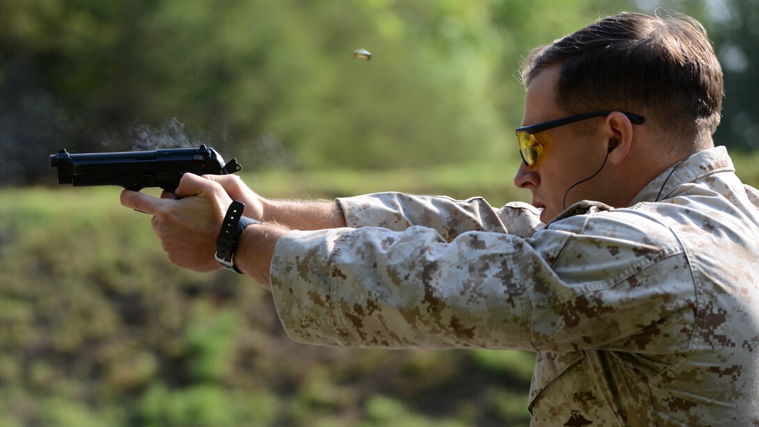 A competitor shoots the pistol portion of a course of fire during the Marine Shooting Team championship at Marine Corps Base Quantico, Virginia, May 24, 2016. The shooters had to rapidly engage targets with the service pistol, rifle and shotgun. The courses were more combat oriented in order to challenge shooters to engage targets quickly and rapidly. 