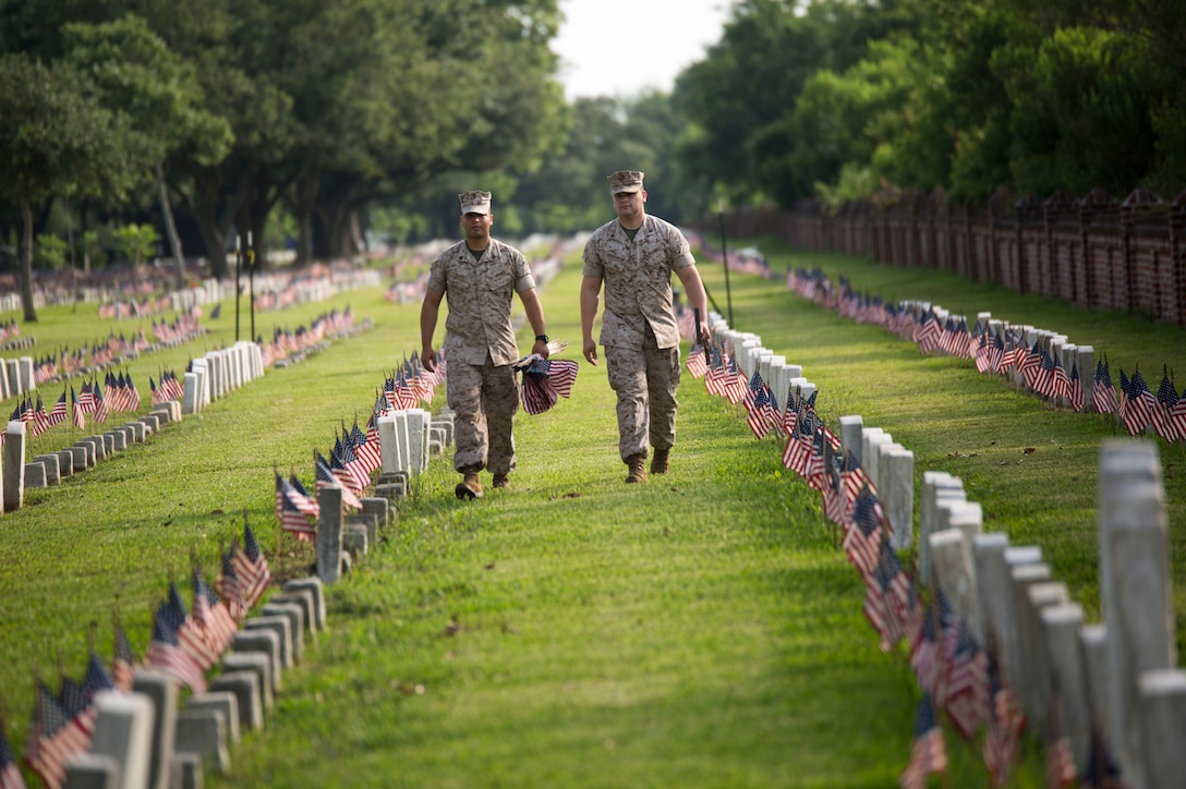 Sgt. Moises Alaniz and Cpl. Joshua Hernandez, Marines from Marine Corps Support Facility New Orleans, walk in between the tombstones of fallen service members during a Memorial Day volunteer event at Chalmette National Cemetery in Chalmette, La., May 27, 2016. The National Park was built on the grounds of the Battle of New Orleans which took place at the end of the War of 1812.  It is now the final resting place for over 15,300 veterans of American military campaigns from the Civil War to the Vietnam War. (U.S. Marine Corps photo by Lance Cpl. Devan A. Barnett)