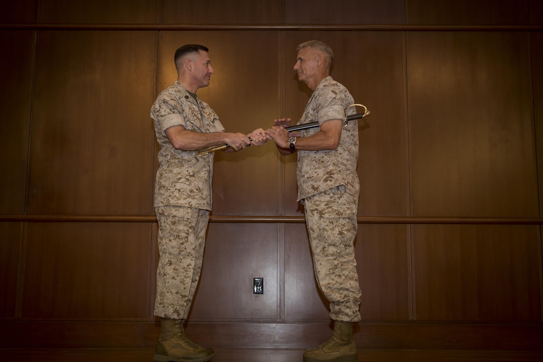 Sgt. Maj. Anthony A. Spadaro, former Marine Forces Reserve and Marine Forces North sergeant major, passes the Noncommissioned Officer sword to Lt. Gen. Rex C. McMillian, commander of Marine Forces Reserve and Marine Forces North during the Relief and Appointment ceremony at Marine Corps Support Facility New Orleans, May 27, 2016. Spadaro, who has been selected to serve as the senior enlisted advisor for U.S. Pacific Command, passes on his duties to Sgt. Maj. Patrick L. Kimble, former sergeant major of 3rd Marine Aircraft Wing.  