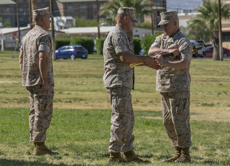 Sgt. Maj. Darren E. Sullivan, oncoming squadron sergeant major, Marine Wing Support Squadron 374, takes the noncommissioned officers’ sword from Lt. Col. Steven Murphy, commanding officer, MWSS-374, during a relief and appointment ceremony at Lance Cpl. Torrey L. Grey Field May 19, 2016. (Official Marine Corps photo by Lance Cpl. Dave Flores)