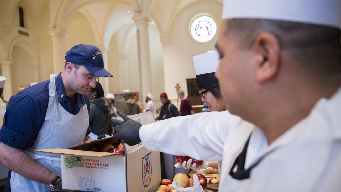U.S. Coast Guard Chief Warrant Officer 2 Aaron Foster, left, marine inspector with Sector New York, and U.S. Navy Petty Officer 1st Class Sergio Arenas, duty armorer with Navy Cargo Handling Battalion 14, prepare meals at the Holy Apostles Soup Kitchen in New York, May 27, 2016 during Fleet Week. U.S. Marines, sailors and coast guardsmen visited the city to interact with the public, demonstrate capabilities and teach the people of New York about America's sea services. 
