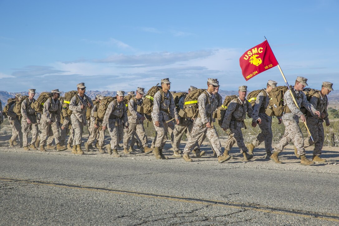 Marines with Marine Wing Support Squadron 374 trek during a 15 km hike from the squadron’s headquarters building to Camp Wilson May 6, 2016. This was the last hike MWSS-374 conducted with their current sergeant major and commanding officer. (Official Marine Corps photos by Lance Cpl. Dave Flores/Released)