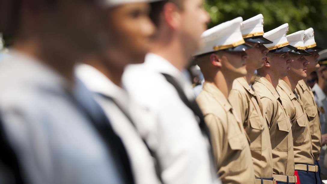 U.S. Marines and sailors stand in formation during a joint promotion and re-enlistment ceremony at the 9/11 Memorial in New York City during Fleet Week, May 27, 2016. U.S. Marines and sailors are in New York to interact with the public, demonstrate capabilities and teach the people of New York about America's sea services.