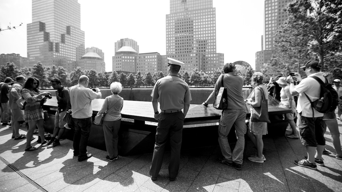 Lance Cpl. Brendan VanDalinda, a machine gunner with 3rd Battalion, 6th Marine Regiment, observes the 9/11 Memorial during Fleet Week in New York City, May 27, 2016. U.S. Marines and sailors are in New York to interact with the public, demonstrate capabilities and teach the people of New York about America's sea services.