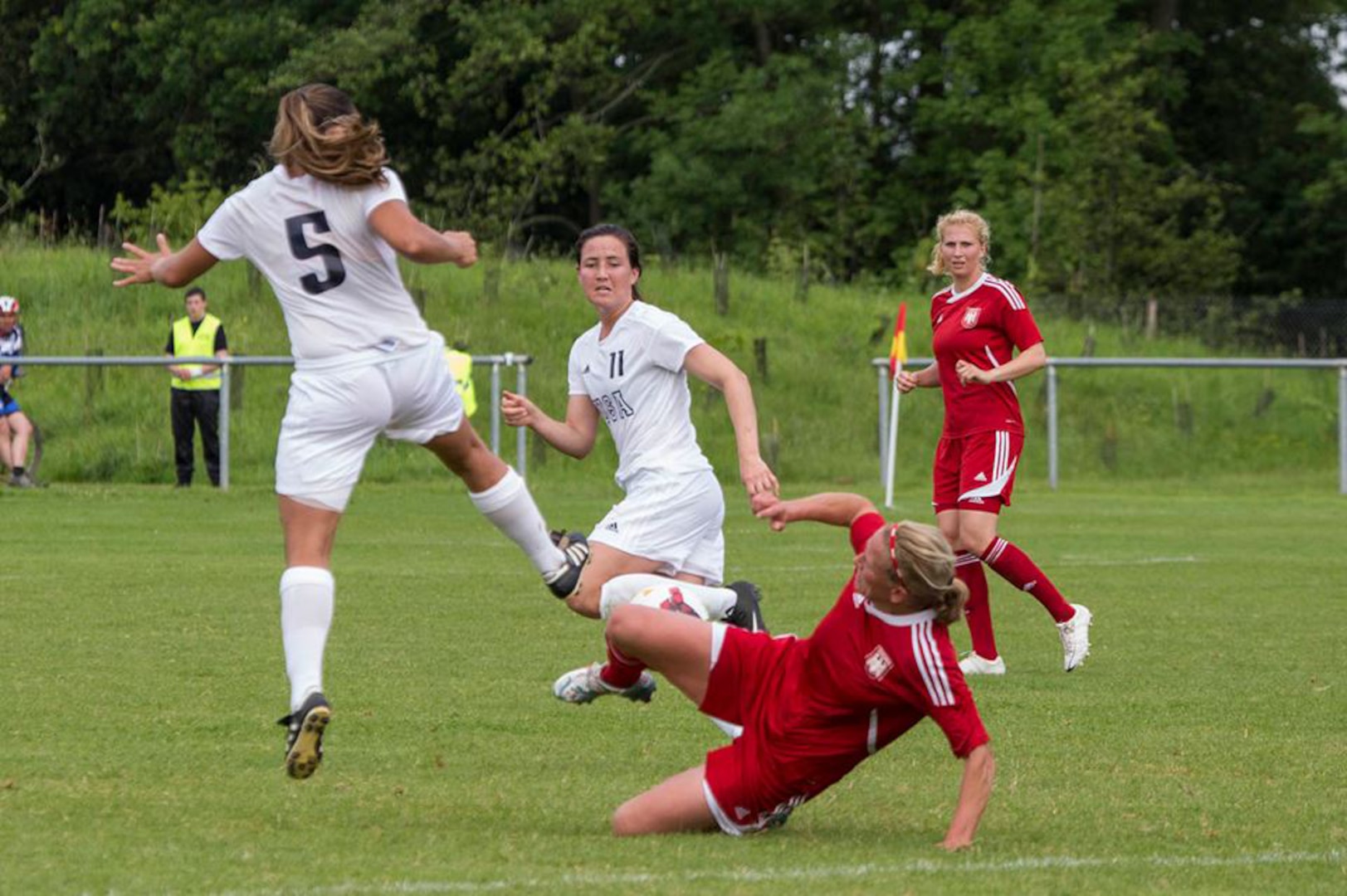 Navy Lt. Christine Hagedorn (#5) of San Diego, Calif. and Army 2nd lt. Harley Spier (#11) take possession against Germany in their opening match of the 2016 Conseil International du Sport Militaire (CISM) World Women's Football Cup in Rennes, France 24 May to 6 June.  