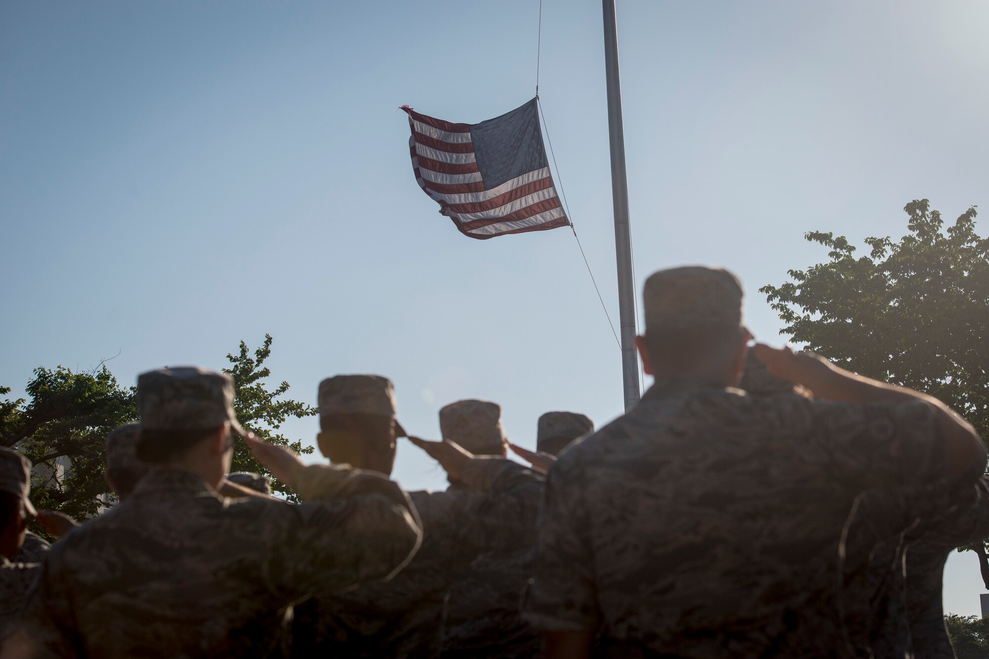 U.S. Air Force Airmen with the 35th Fighter Wing salute the American flag as it is lowered during a Memorial Day retreat ceremony at Misawa Air Base, Japan, May 27, 2016. For nearly seven decades, Airmen have selflessly and courageously fought in conflicts around the globe, providing unrivaled Airpower capabilities and risking their lives to support and defend the Unites States and its allies around the world. (U.S. Air Force photo by Staff Sgt. Benjamin W. Stratton)