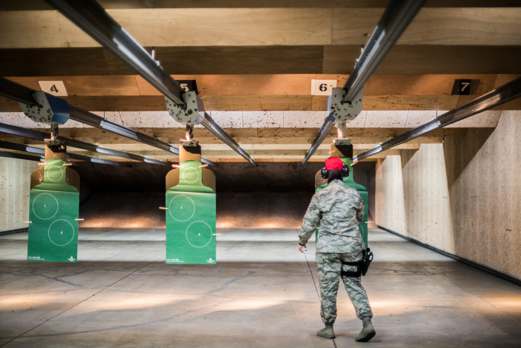 U.S. Air Force Senior Airman Lauren Moschell, a range safety official and acting NCO in charge of physical security with the 35th Security Forces Squadron, hangs a target in the combat arms training and maintenance range at Misawa Air Base, Japan, May 25, 2016. Moschell had to take a five-day course to become qualified as a RSO. With this position, she ensures everyone on the firing line practices proper safety procedures such as weapons level and down-range, no horseplay and follows the tower official’s instructions. (U.S. Air Force photo by Senior Airman Brittany A. Chase)