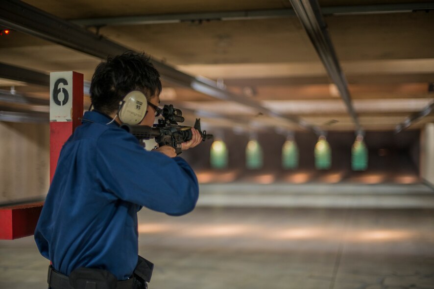 Keigo Kadowaki, a civilian guard patrolman and Apple Gate installation entry controller with the 35th Security Forces Squadron, fires a M-4 rifle in the combat arms training and maintenance range at Misawa Air Base, Japan, May 25, 2016. Kadowaki was a part of the two-day training course and qualified on the M-4 rifle. (U.S. Air Force photo by Senior Airman Brittany A. Chase)