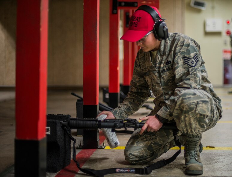 U.S. Air Force Staff Sgt. Chelsea Moschell, an assistant NCO in charge of combat arms with the 35th Security Forces Squadron, cleans an M-4 rifle at Misawa Air Base, Japan, May 25, 2016. Making sure the chamber is properly cleaned and lubricated helps to eliminate ammunition jamming while firing the weapon. (U.S. Air Force photo by Senior Airman Brittany A. Chase