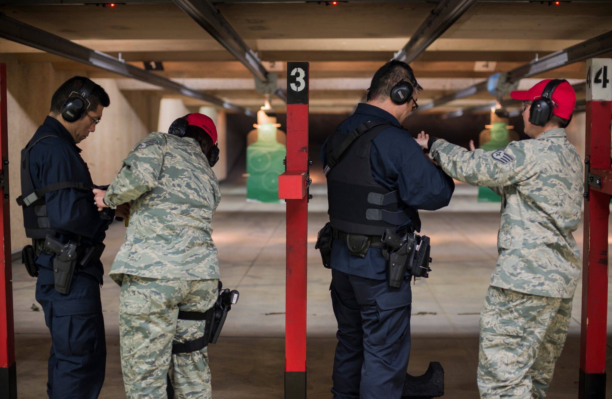 U.S. Air Force Staff Sgt. Chelsea Moschell (right), an assistant NCO in charge of combat arms with the 35th Security Forces Squadron, and Senior Airman Lauren Moschell, a range safety official and acting NCOIC of physical security with the 35th SFS, check Japanese National Civilian Guard members weapons at Misawa Air Base, Japan, May 25, 2016. The Moschell’s help to ensure Air Force personnel who have to carry a weapon during their day-to-day mission know how to operate it, be proficient and be safe with the rifle. (U.S. Air Force photo by Senior Airman Brittany A. Chase)