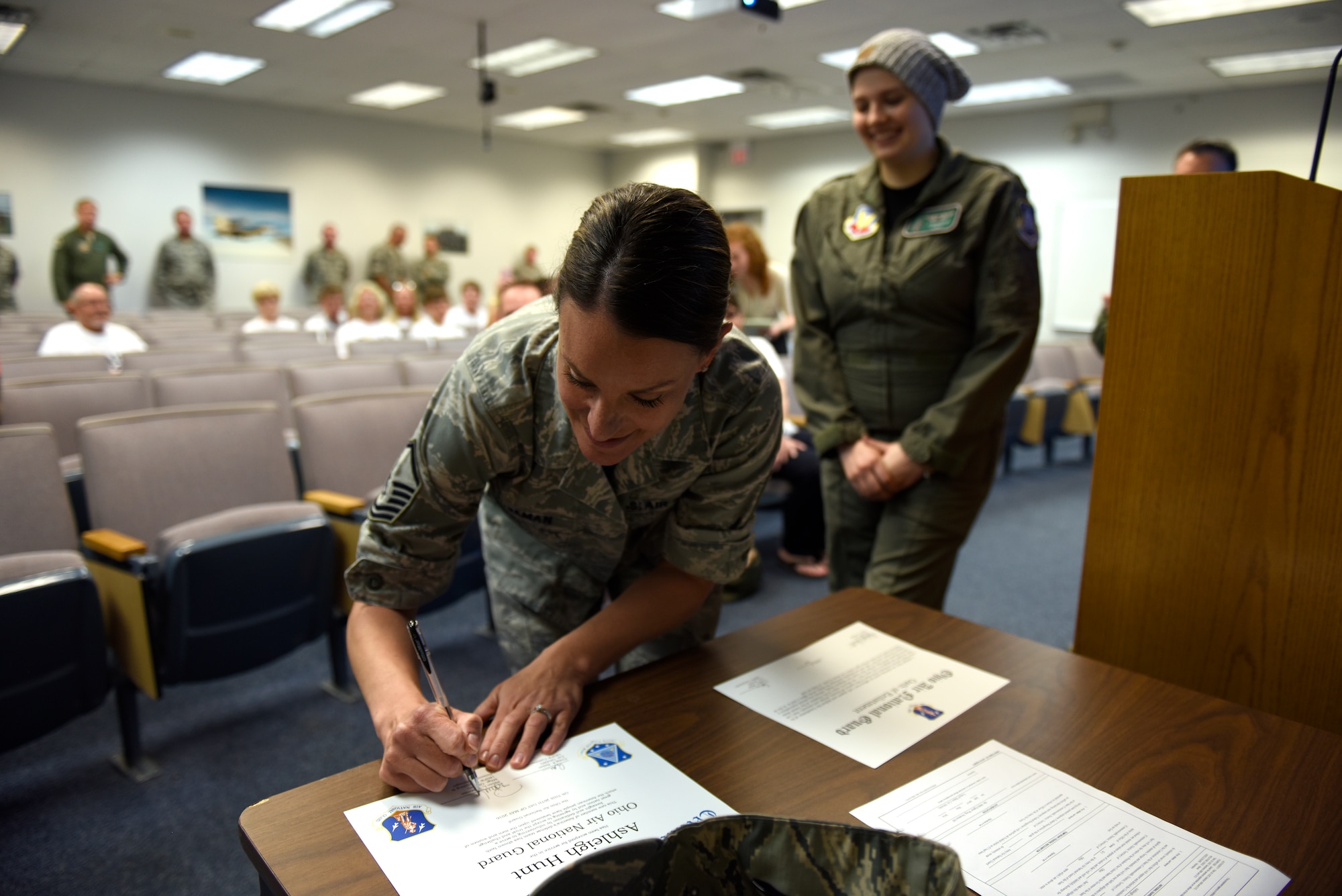 U.S. Air Force Master Sgt. Robin L. Wiseman, a recruiting and retention manager assigned to the 180th Fighter Wing, signs the oath of enlistment May 26, 2016 after commissioning Ashleigh Hunt as an honorary 2nd Lt. in the Ohio Air National Guard during the first-ever Pilot for a Day event at the 180FW. The Pilot for a Day program is a way for the 180FW to support the local community by providing a fun-filled day for children and young adults living with chronic or life-threatening disease or illness. (U.S. Air National Guard photo by Staff Sgt. Shane Hughes)