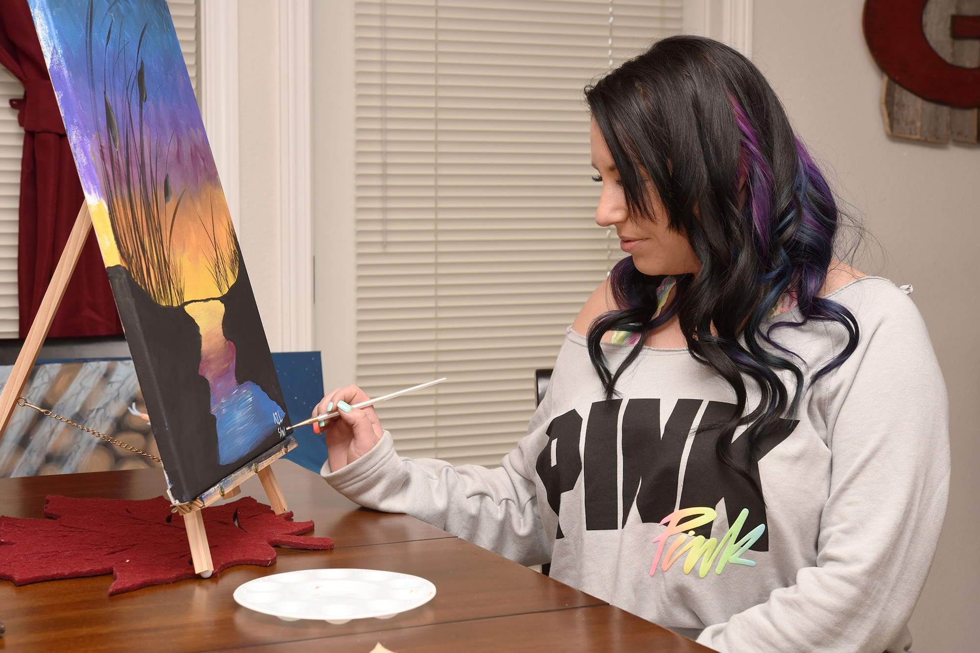 Amanda Lineback, 341st Force Support Squadron youth center aide, finishes up a painting May 25, 2016, at Malmstrom Air Force Base, Mont. Lineback has been painting for two months and learned her skill while attending a painting class. (U.S. Air Force photo/Senior Airman Jaeda Tookes)